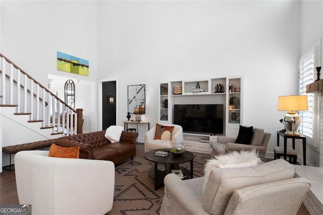 9 Grove Pointe Way, Cartersville, GA 30120 - living area featuring a towering ceiling, stairs, and wood finished floors