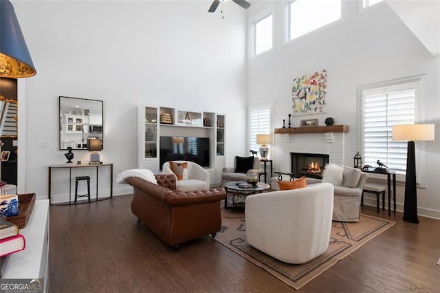 9 Grove Pointe Way, Cartersville, GA 30120 - living area featuring a towering ceiling, wood finished floors, ceiling fan, a fireplace, and healthy amount of natural light