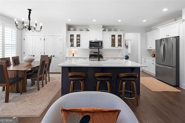 9 Grove Pointe Way, Cartersville, GA 30120 - kitchen with stainless steel appliances, a chandelier, a sink, an island with sink, and backsplash