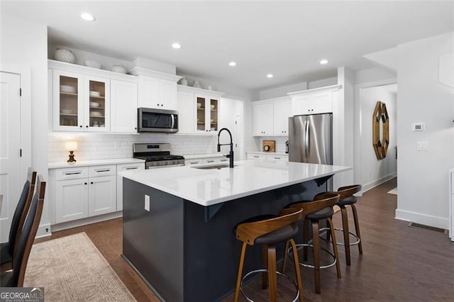9 Grove Pointe Way, Cartersville, GA 30120 - kitchen with appliances with stainless steel finishes, a sink, decorative backsplash, dark wood-type flooring, and recessed lighting