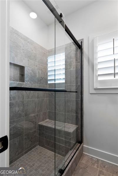9 Grove Pointe Way, Cartersville, GA 30120 - bathroom with healthy amount of natural light, a stall shower, and baseboards