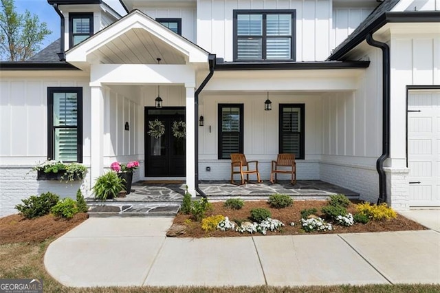 9 Grove Pointe Way, Cartersville, GA 30120 - view of exterior entry with a porch, board and batten siding, and an attached garage