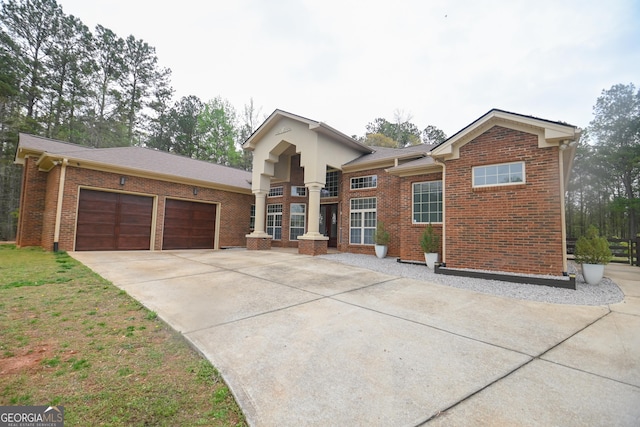 412 Trilium Trl, Pendergrass, GA 30567 - view of front of house featuring driveway, an attached garage, and brick siding