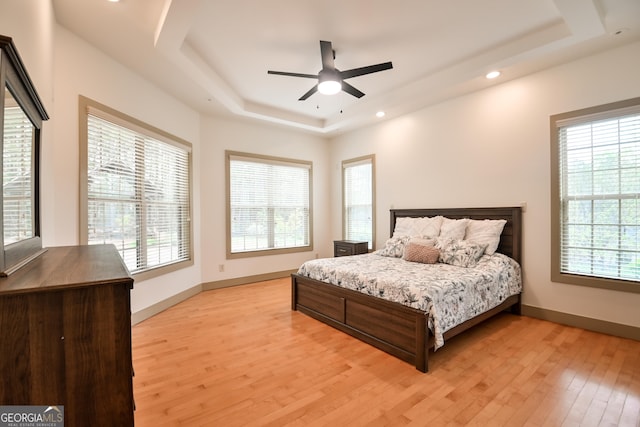 412 Trilium Trl, Pendergrass, GA 30567 - bedroom featuring a tray ceiling, light wood-style flooring, multiple windows, recessed lighting, and baseboards