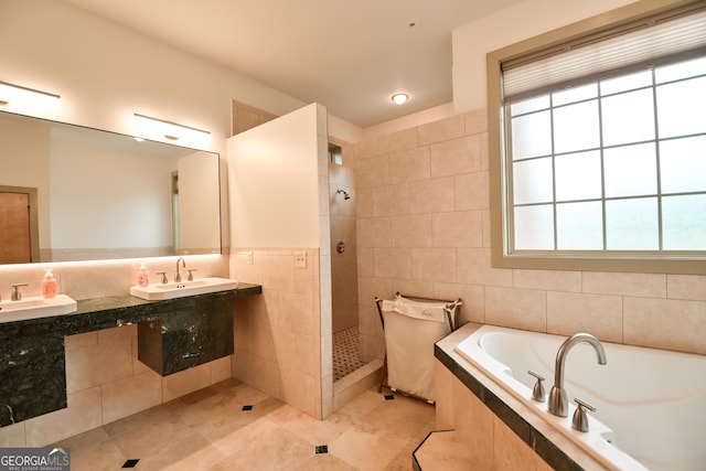 412 Trilium Trl, Pendergrass, GA 30567 - full bathroom featuring tile walls, a garden tub, a walk in shower, tile patterned flooring, and healthy amount of natural light