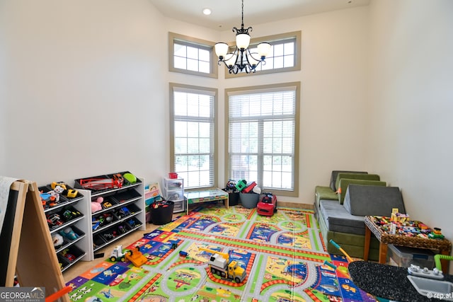 412 Trilium Trl, Pendergrass, GA 30567 - recreation room featuring a chandelier and plenty of natural light