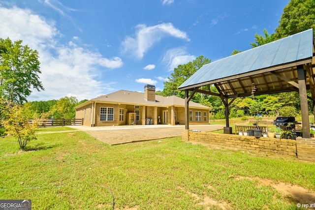412 Trilium Trl, Pendergrass, GA 30567 - back of house featuring a chimney, a gazebo, and a patio