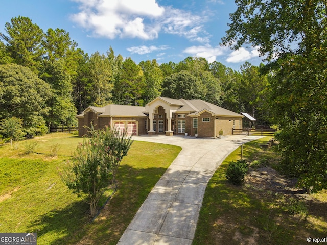 412 Trilium Trl, Pendergrass, GA 30567 - ranch-style house with brick siding, an attached garage, concrete driveway, and a view of trees