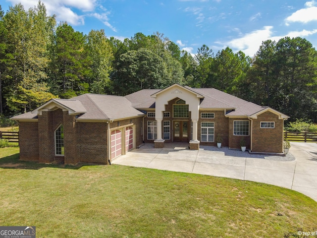 412 Trilium Trl, Pendergrass, GA 30567 - view of front facade with brick siding, driveway, and a garage
