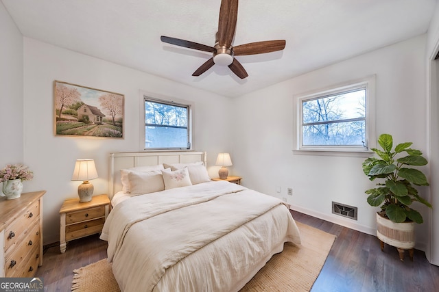 bedroom featuring ceiling fan, baseboards, and wood finished floors