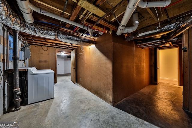 unfinished basement with washer / clothes dryer and electric panel