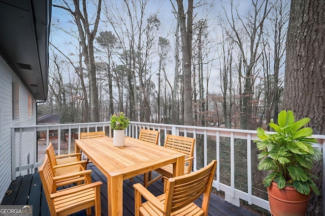 wooden terrace featuring outdoor dining area