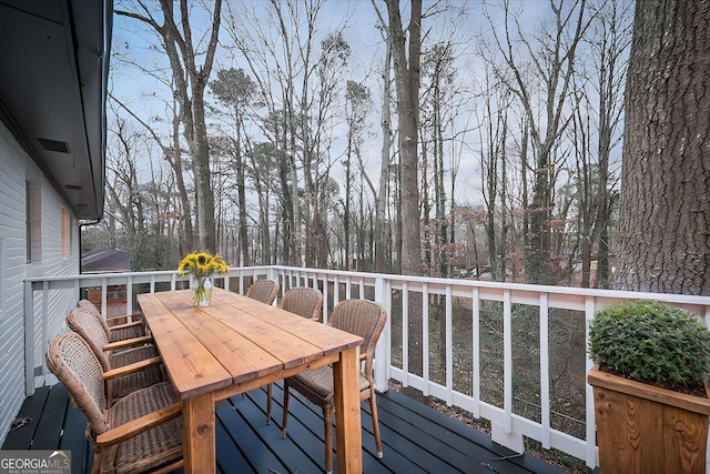 wooden terrace with outdoor dining area