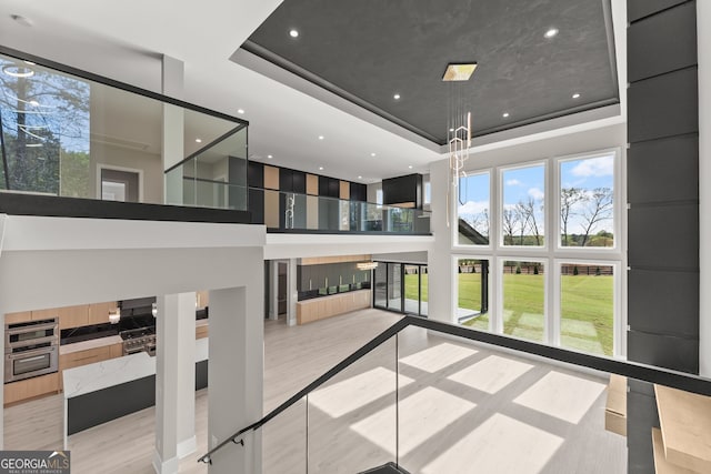 interior space with a high ceiling and a raised ceiling