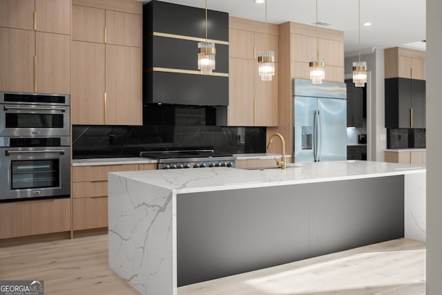 kitchen featuring modern cabinets, a sink, and appliances with stainless steel finishes