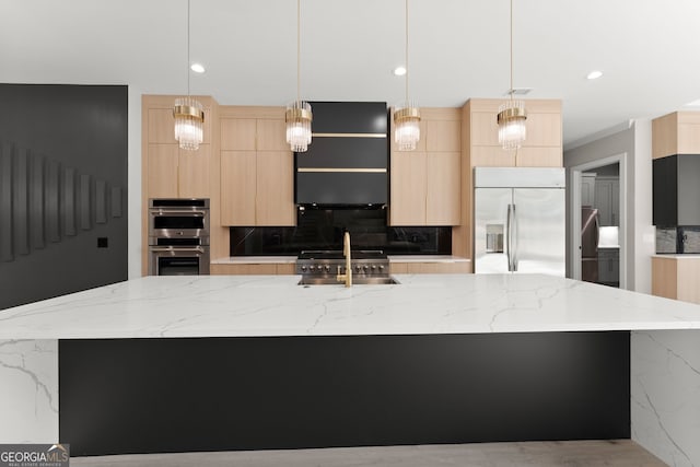 kitchen with a sink, light brown cabinets, appliances with stainless steel finishes, and modern cabinets