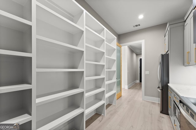 interior space featuring visible vents and light wood-style floors