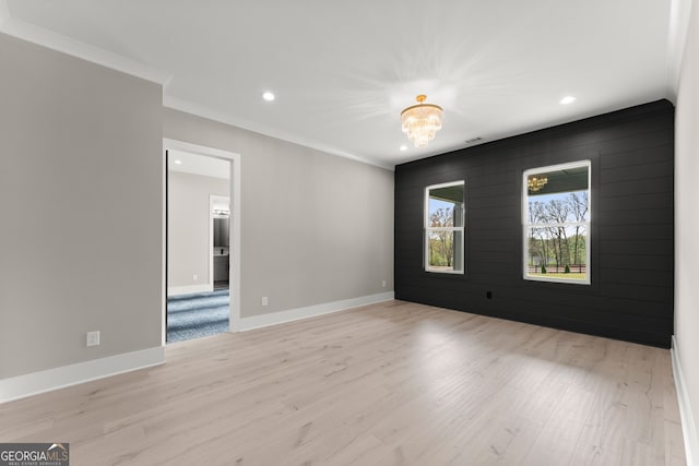 spare room featuring baseboards, recessed lighting, light wood-style floors, and crown molding