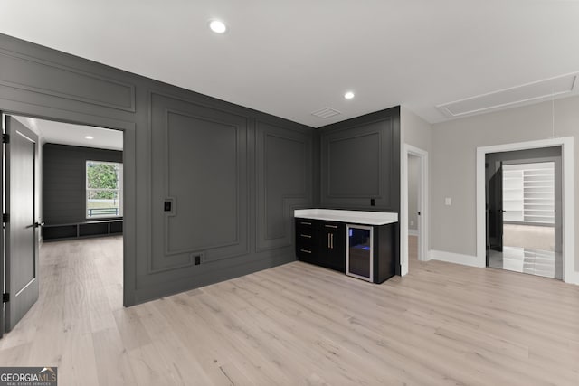 bar with recessed lighting, light wood-type flooring, baseboards, visible vents, and a decorative wall