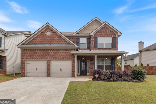 craftsman inspired home with concrete driveway, a front yard, brick siding, a garage, and fence