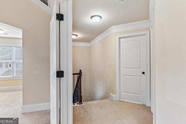 interior space with visible vents, baseboards, an upstairs landing, crown molding, and carpet floors