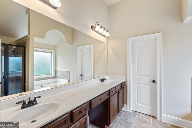 bathroom featuring a shower stall, tile patterned floors, a bath, and a sink