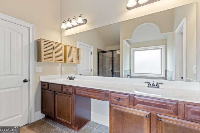 full bathroom featuring a sink, a shower stall, tile patterned flooring, and double vanity