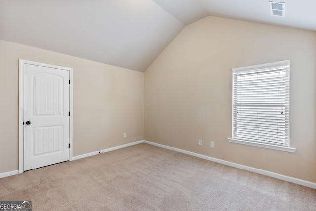 additional living space featuring carpet, visible vents, baseboards, and vaulted ceiling