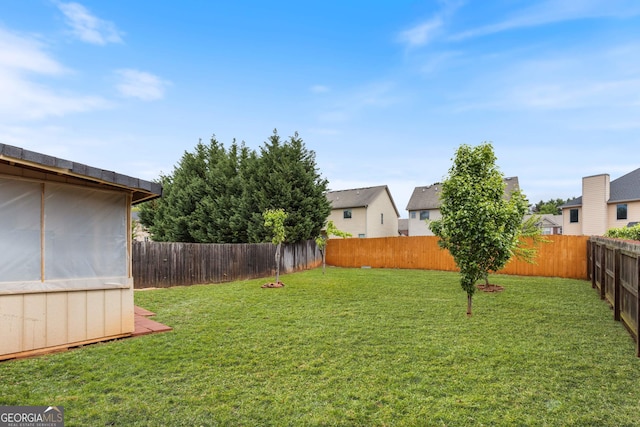 view of yard with a fenced backyard and a residential view