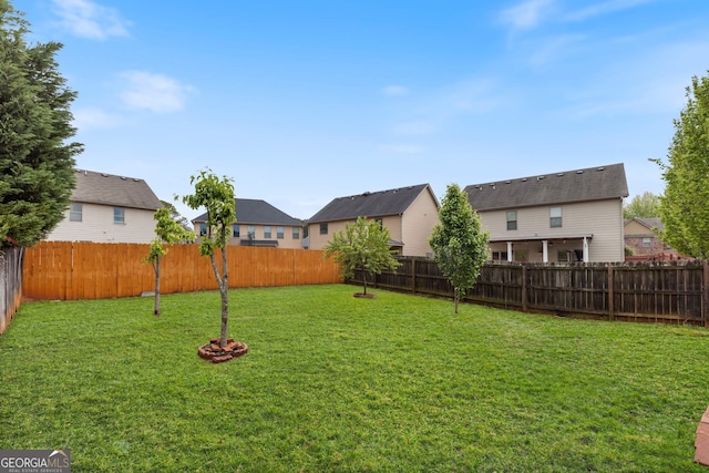 view of yard with a residential view and a fenced backyard