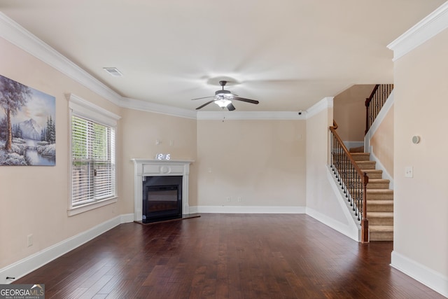 unfurnished living room featuring a glass covered fireplace, dark wood finished floors, visible vents, and ceiling fan