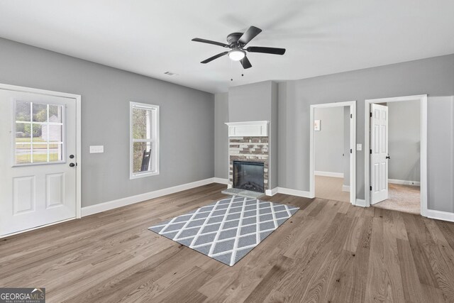 121 Tricias Way, Temple, GA 30179 - kitchen with a glass covered fireplace, a sink, light wood-style floors, dark brown cabinets, and appliances with stainless steel finishes