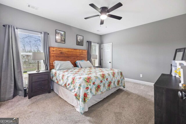121 Tricias Way, Temple, GA 30179 - living area with baseboards, wood finished floors, a glass covered fireplace, and a ceiling fan