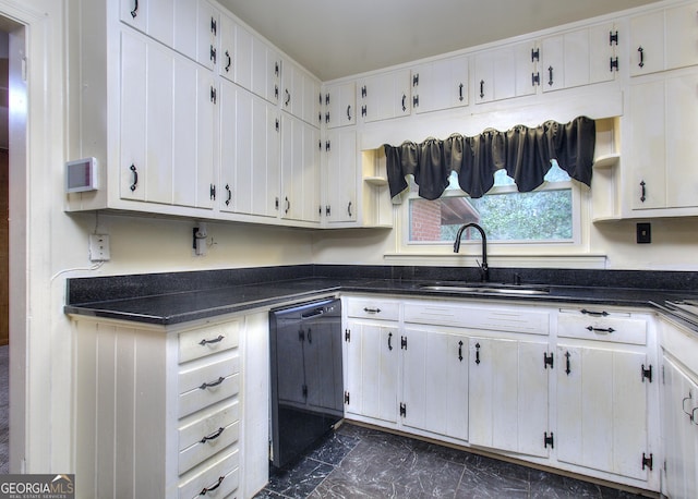 kitchen featuring marble finish floor, a sink, dark countertops, white cabinets, and black dishwasher