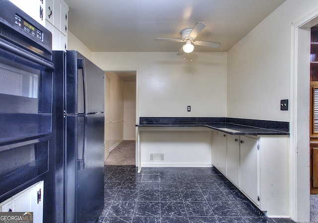 kitchen with visible vents, ceiling fan, dark countertops, white cabinetry, and freestanding refrigerator