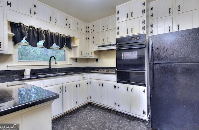 kitchen featuring a sink, white cabinetry, a warming drawer, under cabinet range hood, and black appliances