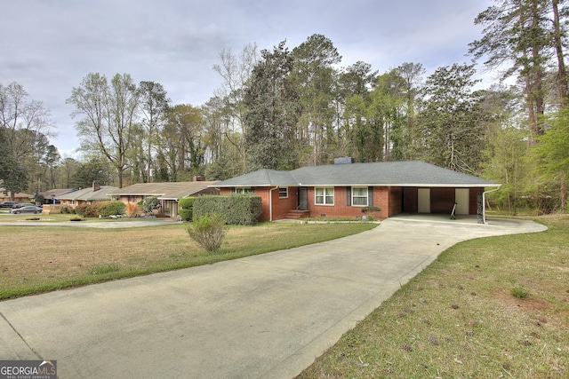 ranch-style house featuring driveway, brick siding, a front yard, and a carport