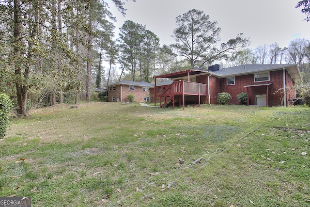 view of yard with stairs and a deck