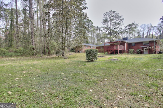 view of yard with a wooden deck