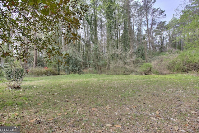 view of yard with a forest view