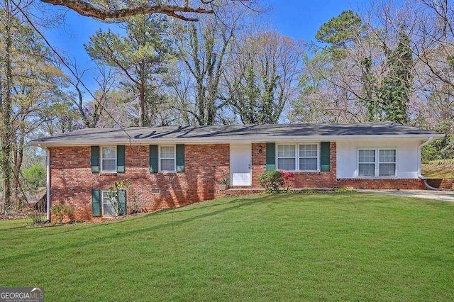 single story home with brick siding and a front yard