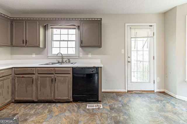 kitchen with black dishwasher, visible vents, a sink, and a textured ceiling