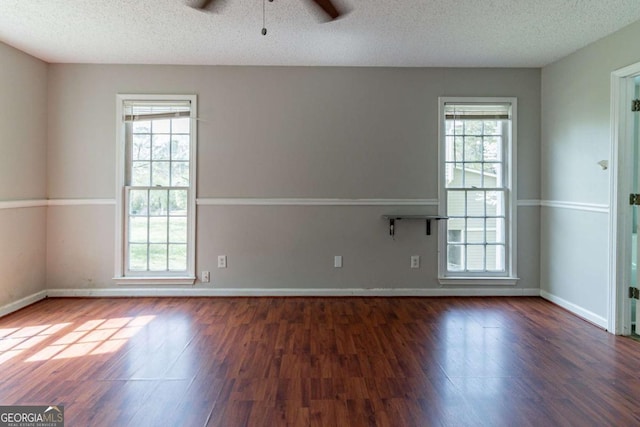 spare room with wood finished floors, plenty of natural light, baseboards, and ceiling fan