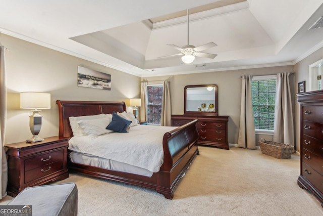 bedroom with a tray ceiling, ceiling fan, crown molding, and light carpet