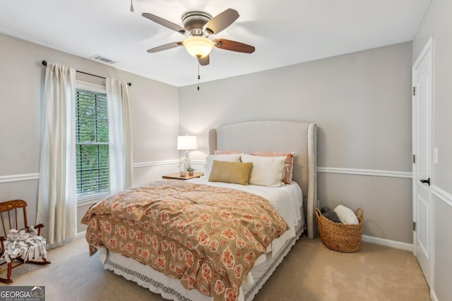 bedroom featuring baseboards, carpet floors, visible vents, and a ceiling fan