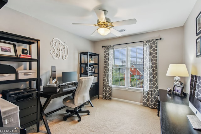 office space with baseboards, carpet floors, ceiling fan, and visible vents