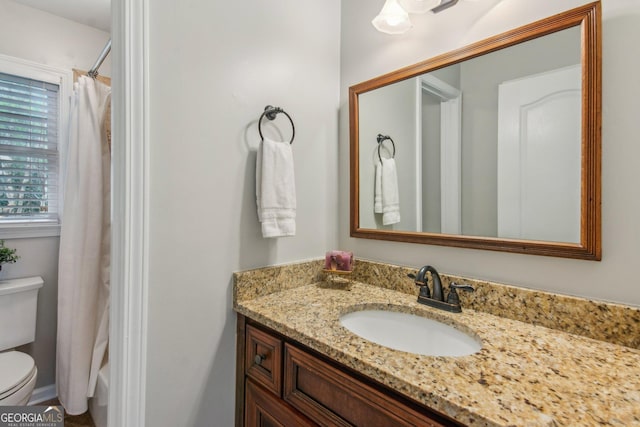 full bathroom with toilet and vanity