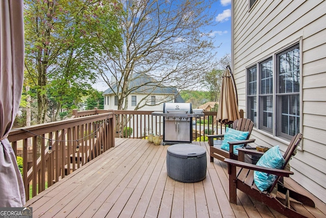 wooden deck featuring area for grilling