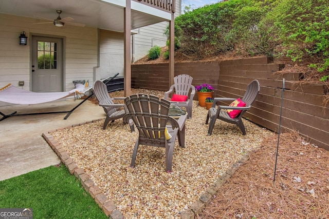 view of patio with a ceiling fan and a fire pit