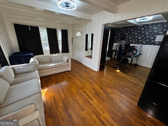 living room featuring beam ceiling and wood finished floors